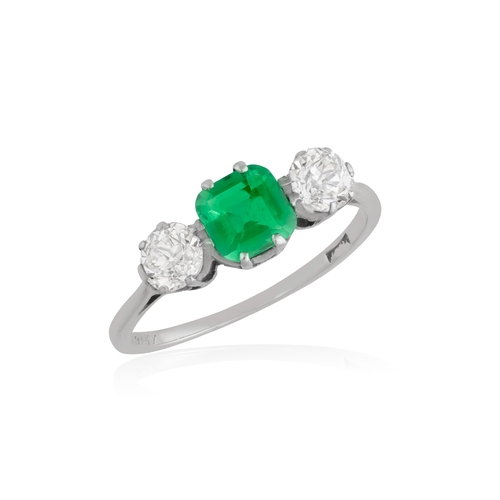 138 - A FINE EMERALD AND DIAMOND THREE-STONE RING  The cushion-shaped emerald set between two brilliant-cu... 