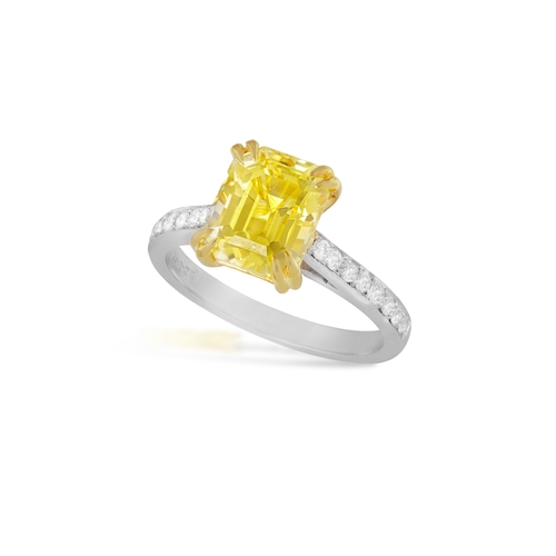 159 - A YELLOW SAPPHIRE AND DIAMOND DRESS RING  The cut-cornered rectangular yellow sapphire, weighing 4.0... 