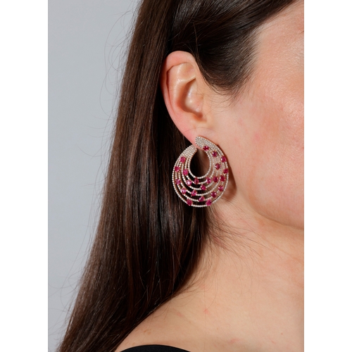 162 - A PAIR OF RUBY AND DIAMOND EARRINGS  Each composed of five graduated concentric hoops, pavé-set with... 