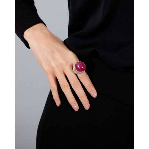 178 - BULGARI: AN IMPORTANT RUBY AND DIAMOND DRESS RING  Composed of a cushion-shaped cabochon ruby, withi... 