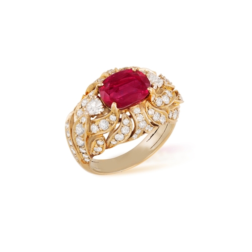 179 - A RUBY AND DIAMOND DRESS RING   Centring a claw-set cushion-shaped ruby weighing approximately 2.60c... 