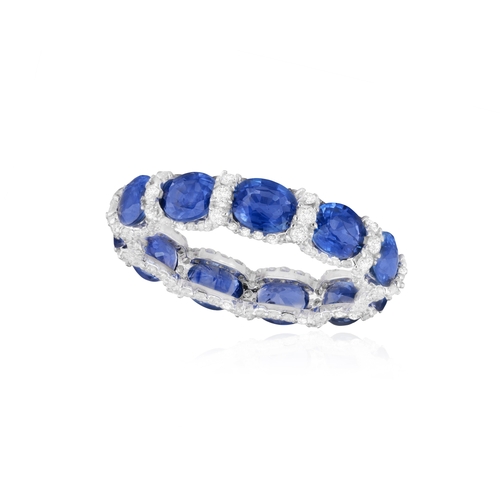 197 - A SAPPHIRE AND DIAMOND RING  Composed of a continuous series of oval-shaped sapphires, interspersed ... 