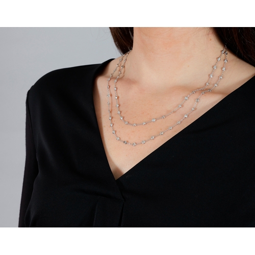 201 - A DIAMOND CHAIN NECKLACE  The cable-link chain interspersed with collet-set brilliant-cut diamonds, ... 