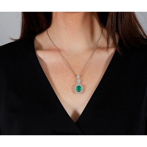 208 - AN EMERALD AND DIAMOND CLUSTER PENDANT ON CHAIN  The cushion-shaped emerald weighing approximately 3... 