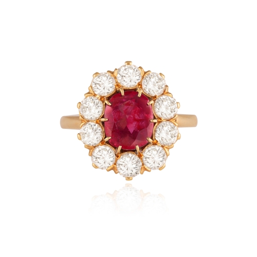 239 - A RUBY AND DIAMOND CLUSTER RING   Centring a cushion-shaped ruby weighing approximately 2.10cts, wit... 