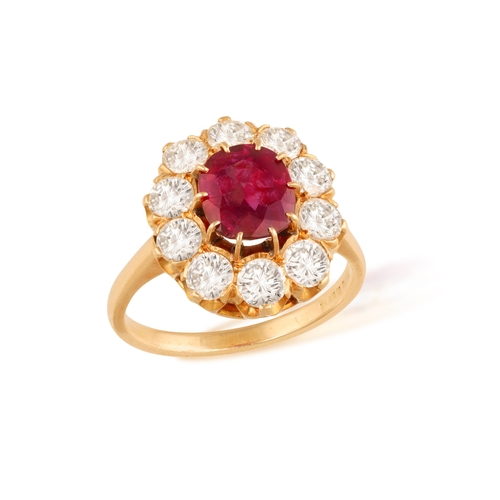 239 - A RUBY AND DIAMOND CLUSTER RING   Centring a cushion-shaped ruby weighing approximately 2.10cts, wit... 