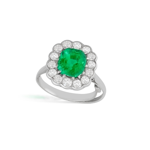 242 - AN EARLY 20TH CENTURY EMERALD AND DIAMOND CLUSTER RING  Set with a cut-cornered rectangular-shaped e... 