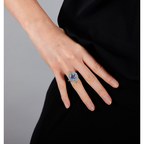 253 - A SAPPHIRE AND DIAMOND DRESS RING  The oval-shaped sapphire weighing 4.60cts, within a four-claw set... 