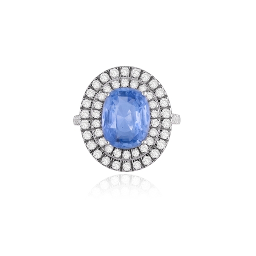 253 - A SAPPHIRE AND DIAMOND DRESS RING  The oval-shaped sapphire weighing 4.60cts, within a four-claw set... 