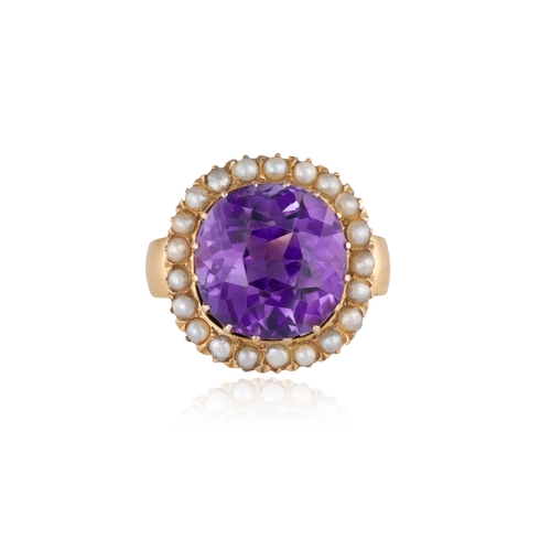 30 - A LATE 19TH CENTURY AMETHYST AND SEED PEARL RING  The cushion-shaped amethyst within a multi-claw se... 