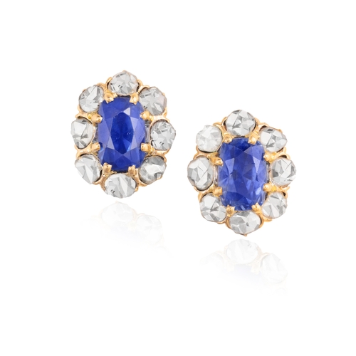 52 - A PAIR OF SAPPHIRE AND DIAMOND CLUSTER EARRINGS  Each oval-shaped sapphire within a rose-cut diamond... 