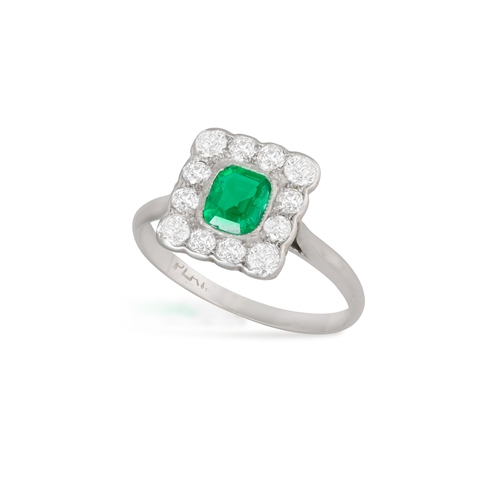 53 - AN EARLY 20TH CENTURY EMERALD AND DIAMOND RING  The square mount set with a rectangular-shaped emera... 