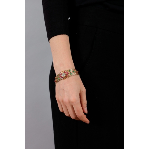 61 - MAUBOUSSIN: A RETRO GEM-SET AND DIAMOND JARRETIÈRE BRACELET, CIRCA 1950  Of articulated textured des... 