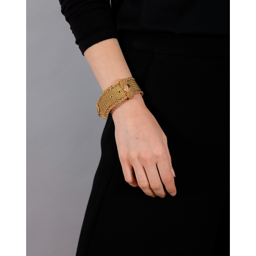 64 - A MID-20TH CENTURY GOLD JARRETIÈRE BRACELET, FRENCH, CIRCA 1955  Composed of a woven strap with rope... 