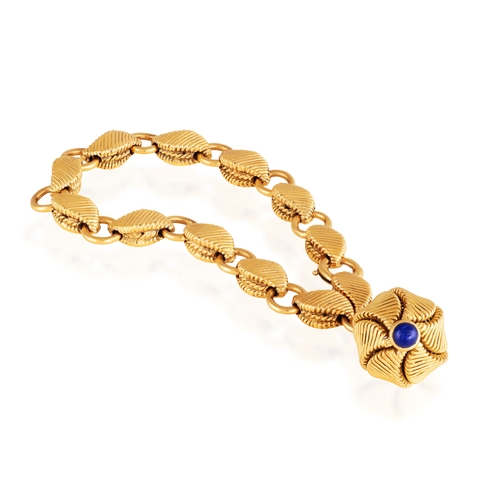 69 - GEORGES LENFANT: A GOLD AND SAPPHIRE CHARM BRACELET, CIRCA 1965  Composed of fancy reeded links with... 