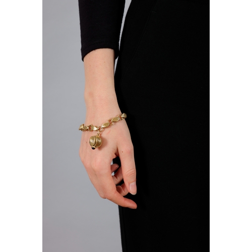 69 - GEORGES LENFANT: A GOLD AND SAPPHIRE CHARM BRACELET, CIRCA 1965  Composed of fancy reeded links with... 