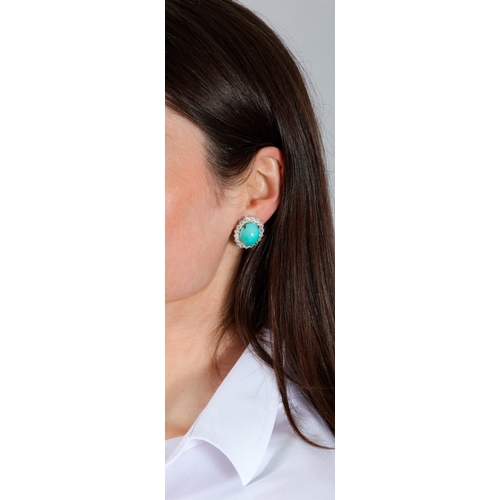 73 - A PAIR OF TURQUOISE AND DIAMOND EARCLIPS, CIRCA 1960   Each set with an oval-shaped cabochon turquoi... 