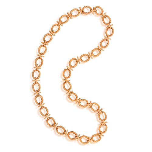 76 - A 9K GOLD NECKLACE  The chain necklace composed of textured gold circular links with X-shaped connec... 