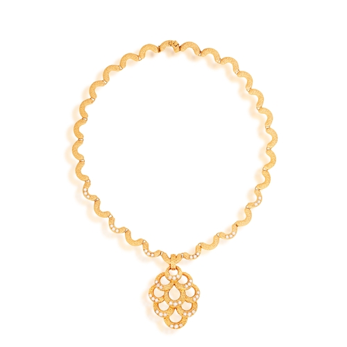 79 - FRED PARIS: A DIAMOND PENDANT NECKLACE, CIRCA 1970  The articulated textured gold chain highlighted ... 