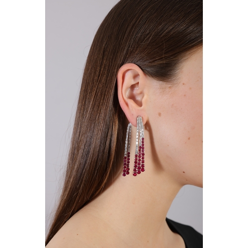 176 - MICHELE DELLA VALLE: A PAIR OF RUBY AND DIAMOND PENDENT EARCLIPS  Each designed as a cascade of bagu... 