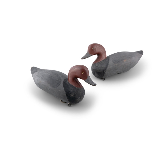 118 - A PAIR OF DECOY DUCKS,   in black, grey and burgundy tones. 34cm long