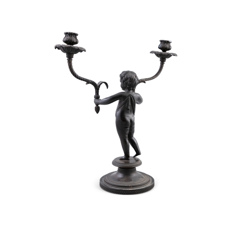 132 - A 19TH CENTURY BRONZE CANDELABRA IN THE FORM OF A YOUNG BOY,   standing, holding a candle sconce in ... 