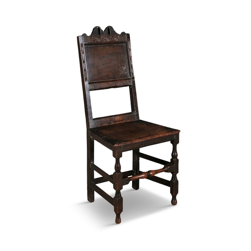 147 - A 17TH CENTURY OAK SIDE CHAIR,   with arched and arcaded top rail over a fielded panel back and seat... 