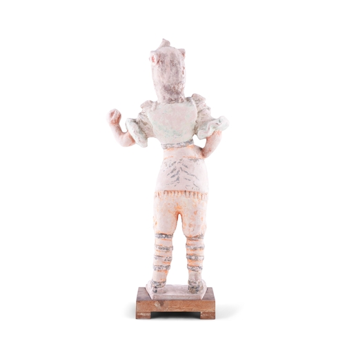 219 - A CHINESE PAINTED TERRACOTTA FIGURE OF A STANDING WARRIOR,   in Han Style, dressed in full armour, w... 