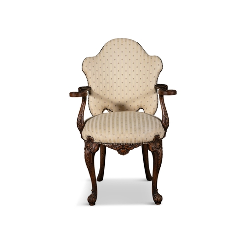 231 - A CONTINENTAL MAHOGANY FRAMED ARMCHAIR, 19TH CENTURY  with arched back, with striped and floral upho... 