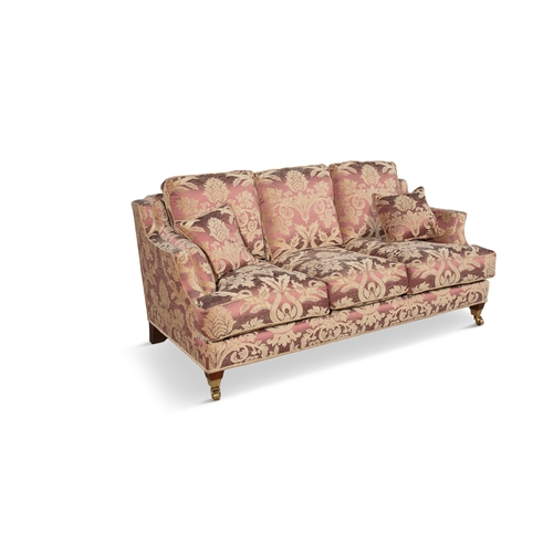 288 - A RED FLORAL DAMASK UPHOLSTERED THREE SEATER SOFA  covered in red and cream fabric, with loose seat ... 