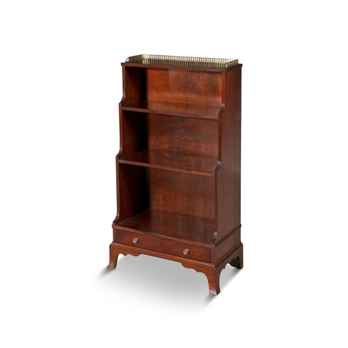 372 - A MAHOGANY AND BRASS MOUNTED THREE TIER WATERFALL BOOKCASE,  the pierced gallery top above three gra... 