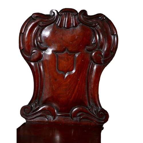 412 - A PAIR OF VICTORIAN MAHOGANY CARVED HALL CHAIRS  each with cartouche shaped panelled back and centre... 