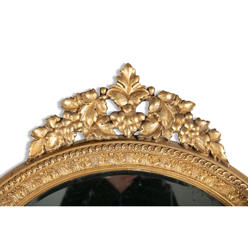 434 - A 19TH CENTURY GILTWOOD AND GESSO OVAL WALL MIRROR,  the bevelled oval plate enclosed with an acanth... 