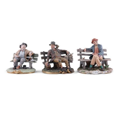 471 - A COLLECTION OF CAPO DI MONTE FIGURES OF TRAMPS   three figures seated on benches, c.24cm wide, 21 -... 