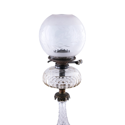 477 - A VICTORIAN CLEAR GLASS TABLE OIL LAMP,  and a clear etched glass shade, 66cm high including shade