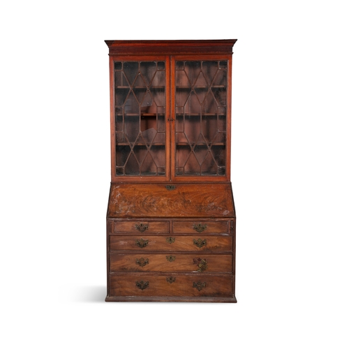 493 - A GEORGE III MAHOGANY SLOPEFRONT BUREAU BOOKCASE,   the moulded cornice above twin astragal glazed p... 