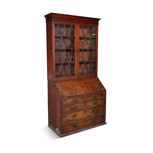 493 - A GEORGE III MAHOGANY SLOPEFRONT BUREAU BOOKCASE,   the moulded cornice above twin astragal glazed p... 