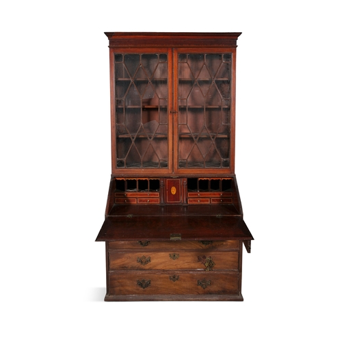 493 - A GEORGE III MAHOGANY SLOPEFRONT BUREAU BOOKCASE,   the moulded cornice above twin astragal glazed p... 