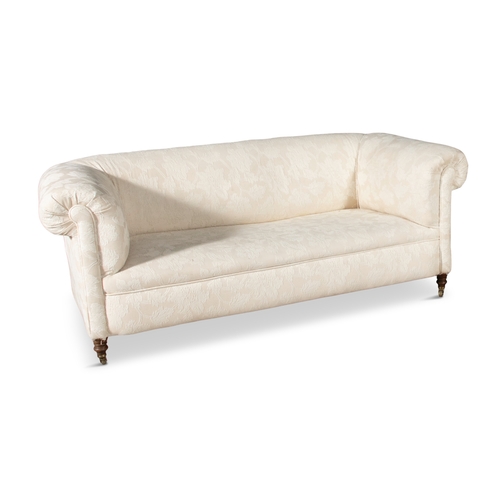 494 - A VICTORIAN MAHOGANY FRAMED CHESTERFIELD COUCH,  covered in a cream floral damask, with out scrollin... 