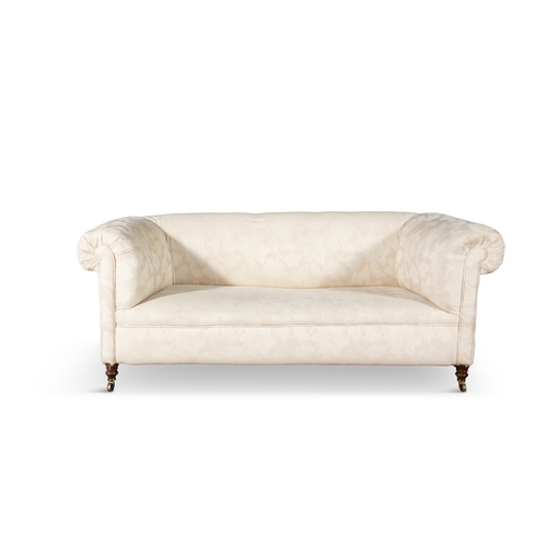 494 - A VICTORIAN MAHOGANY FRAMED CHESTERFIELD COUCH,  covered in a cream floral damask, with out scrollin... 