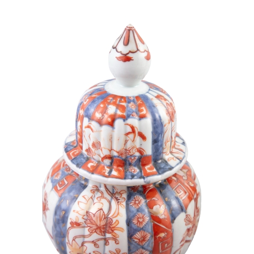 71 - A PAIR OF IMARI PATTERN PORCELAIN VASES AND COVERS  each with domed cover with pointed finial, of ov... 