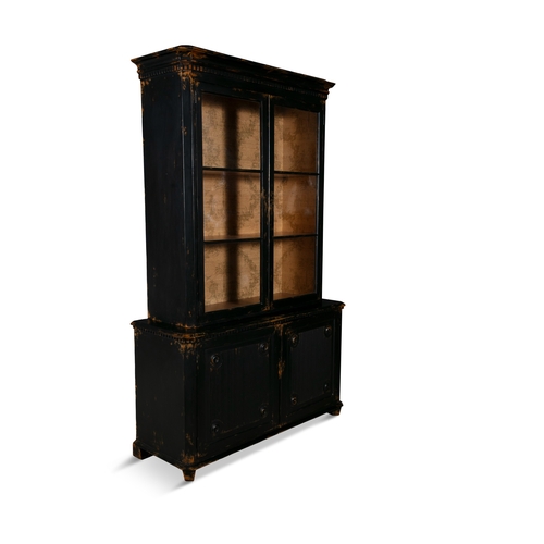 72 - A BLACK PAINTED TIMBER TWO DOOR CABINET,  with outset cornice over twin glazed doors enclosing shelv... 