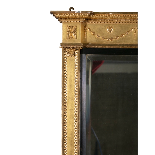 73 - A GILTWOOD COMPARTMENTED OVERMANTLE MIRROR IN THE NEO-CLASSICAL STYLE   with three bevelled glass pl... 