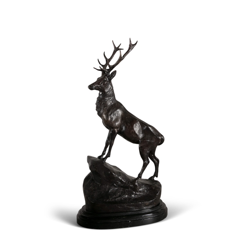 74 - AFTER JULES MOIGNIEZ 20TH CENTURY,  a pair of bronze stags, each modelled standing on a rock mound o... 