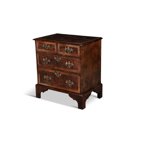 87 - A GEORGIAN STYLE WALNUT CROSSBANDED BACHELOR'S CHEST,  the moulded rectangular top with geometric in... 