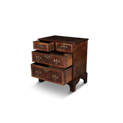 87 - A GEORGIAN STYLE WALNUT CROSSBANDED BACHELOR'S CHEST,  the moulded rectangular top with geometric in... 