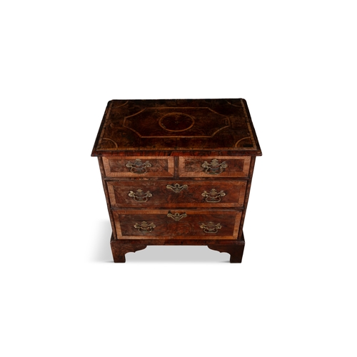 87 - A GEORGIAN STYLE WALNUT CROSSBANDED BACHELOR'S CHEST,  the moulded rectangular top with geometric in... 