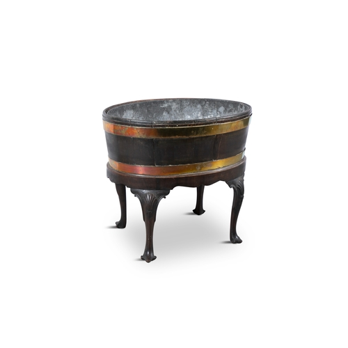 24 - AN OVAL MAHOGANY AND BRASS BOUND WINE COOLER, C.1800   with detachable zinc liner, on a fitted stand... 