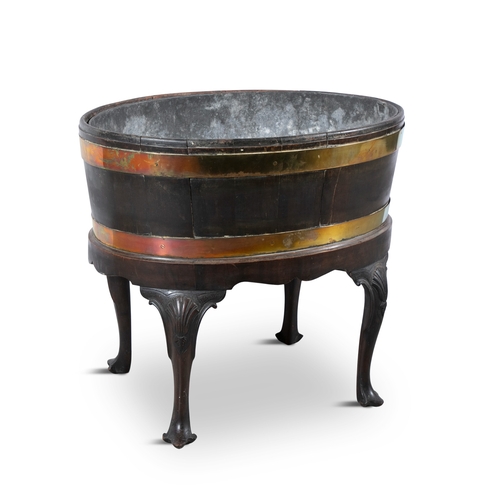 24 - AN OVAL MAHOGANY AND BRASS BOUND WINE COOLER, C.1800   with detachable zinc liner, on a fitted stand... 