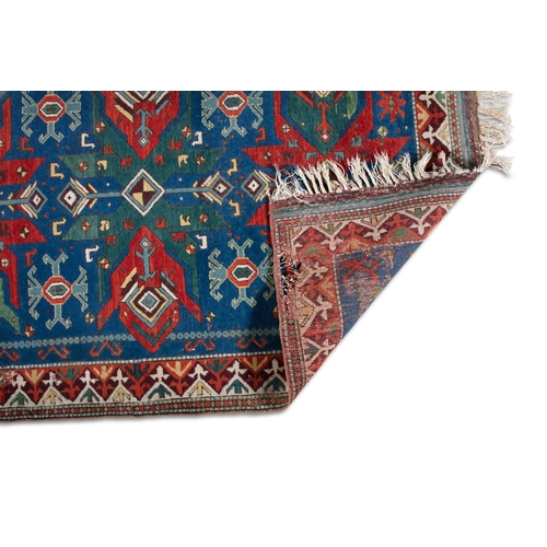 26 - A KAZAK WOOL RUG. 125 X 183CM   the rectangular blue ground woven with lozenges hooked motifs and ca... 